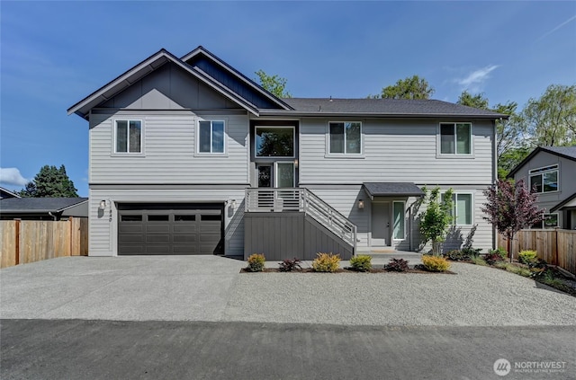 view of front facade featuring fence, a garage, and driveway