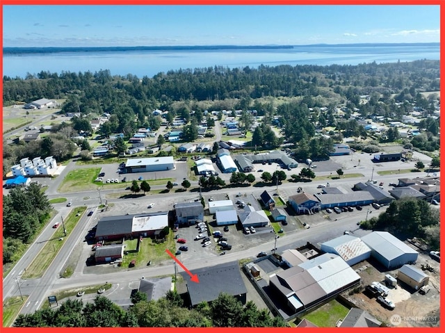 birds eye view of property with a water view