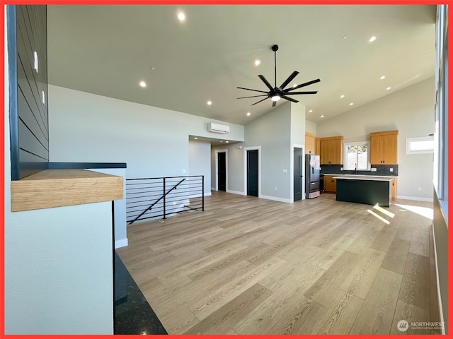 living room with high vaulted ceiling, light wood-type flooring, and ceiling fan