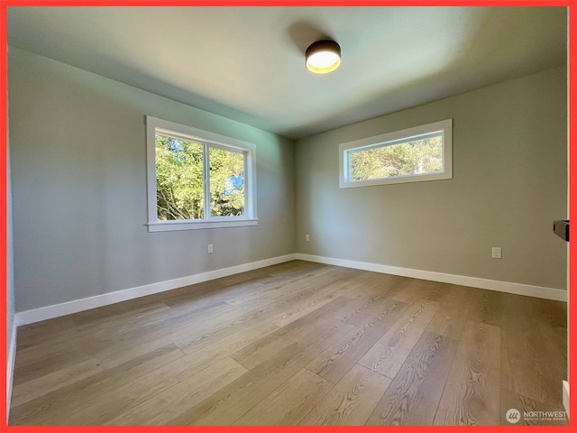 unfurnished room with light hardwood / wood-style flooring