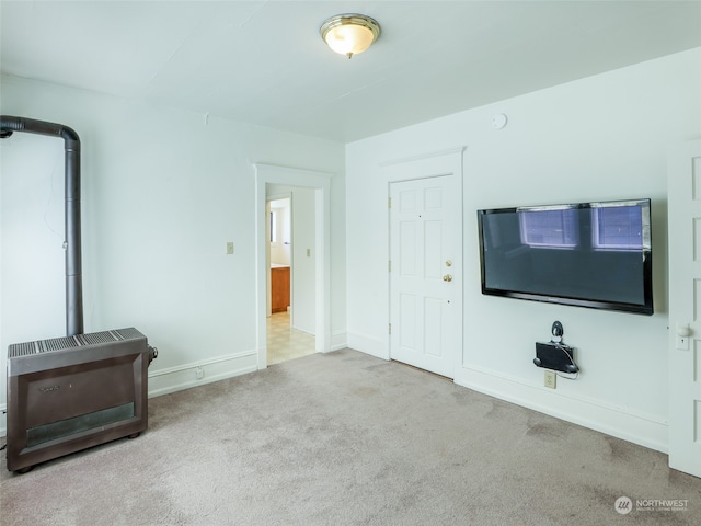 unfurnished living room featuring light carpet