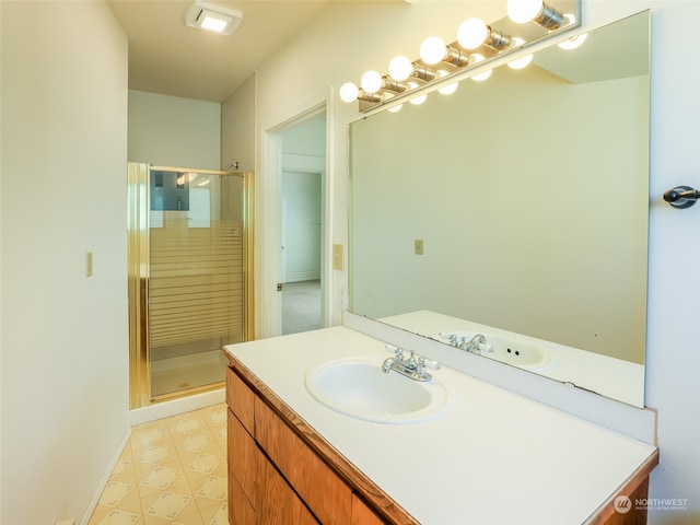 bathroom featuring vanity and an enclosed shower