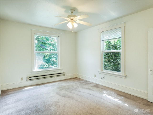 carpeted empty room with a baseboard heating unit and ceiling fan