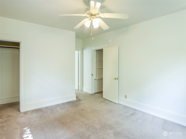 unfurnished bedroom featuring light carpet, a closet, and ceiling fan