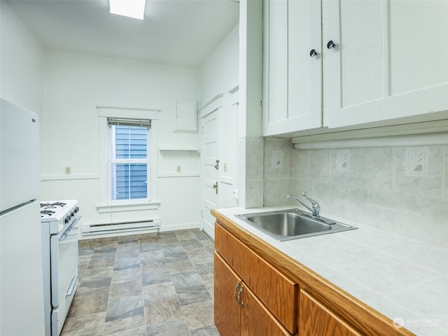 kitchen with sink, white cabinetry, white appliances, baseboard heating, and tile countertops