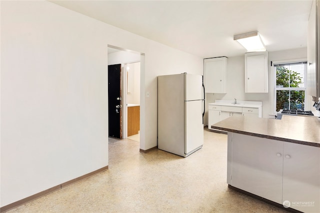 kitchen with white cabinets and white refrigerator