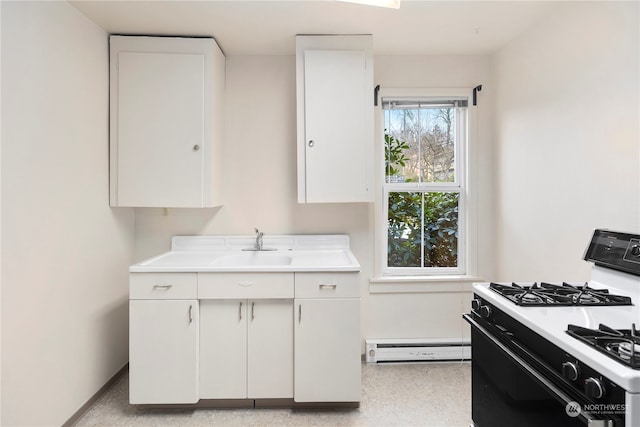 kitchen with white cabinets, a baseboard radiator, sink, and gas range gas stove