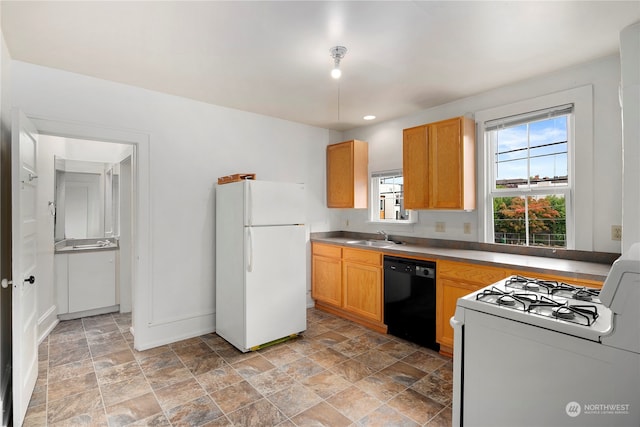 kitchen with white appliances, sink, and plenty of natural light