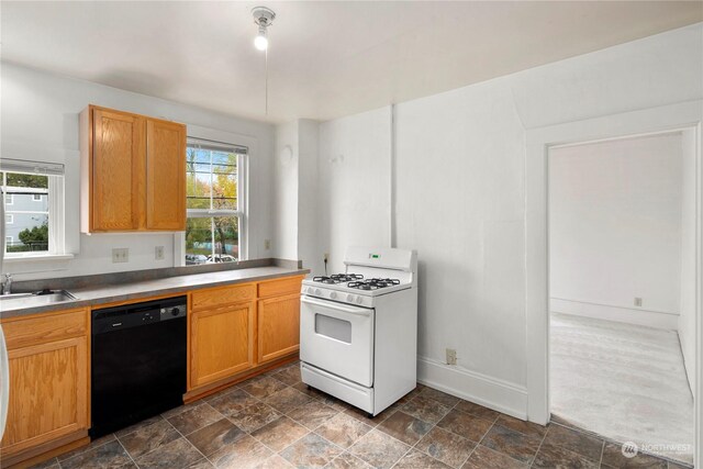 kitchen with black dishwasher, sink, white range with gas cooktop, and a healthy amount of sunlight