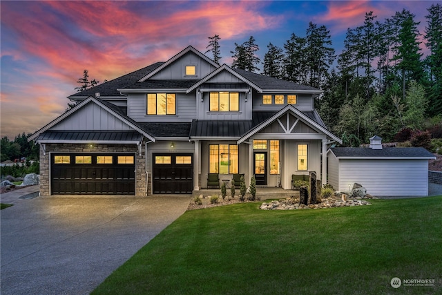 craftsman-style home featuring a garage, a yard, and covered porch