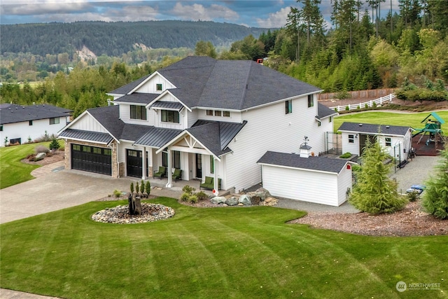 view of front of home featuring a storage unit, a front lawn, and a garage