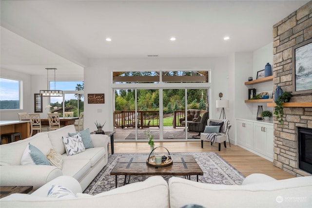 living room with a fireplace and light wood-type flooring