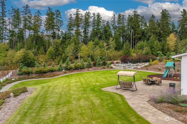 view of yard with a playground and a patio