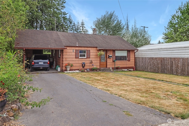 view of front of home with a front lawn and a carport