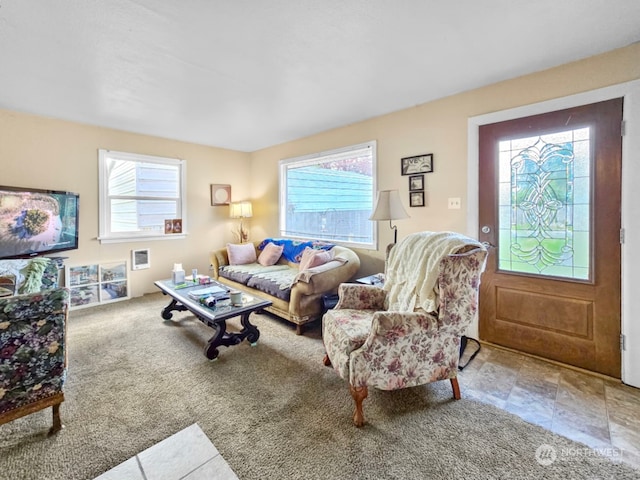 living room with carpet flooring and a wall mounted air conditioner