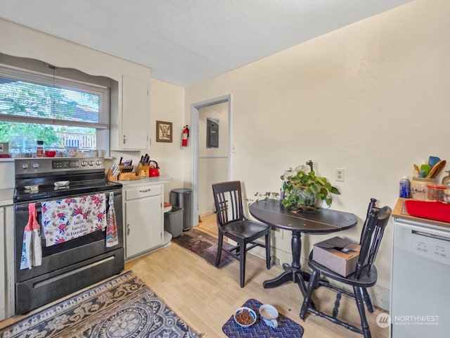 kitchen with light hardwood / wood-style flooring, white dishwasher, white cabinetry, and black range with electric stovetop