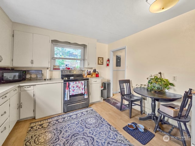 kitchen featuring stainless steel range with electric stovetop, light hardwood / wood-style flooring, and white cabinetry