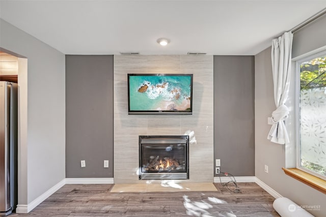 unfurnished living room featuring hardwood / wood-style flooring and a fireplace