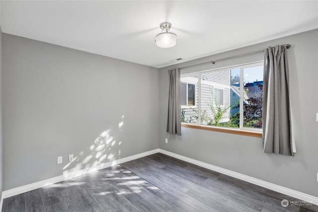 spare room featuring dark hardwood / wood-style floors