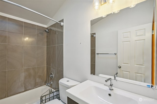 full bathroom featuring vaulted ceiling, vanity, tiled shower / bath, and toilet