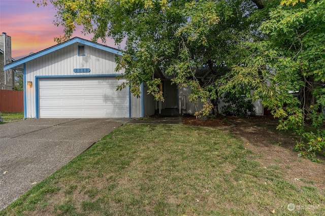 view of front of property featuring a yard and a garage