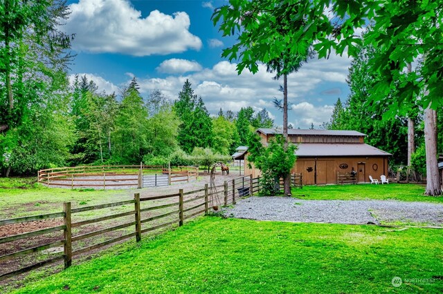 view of yard featuring a rural view and an outbuilding