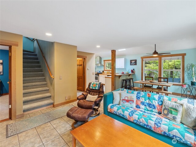 tiled living room featuring ceiling fan