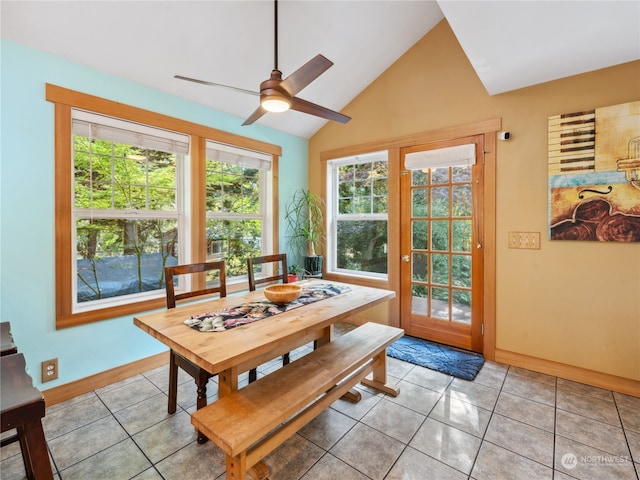 tiled dining room with lofted ceiling, ceiling fan, and a wealth of natural light