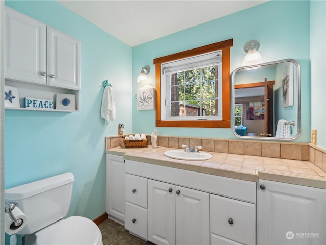 bathroom featuring vanity, toilet, and tile patterned floors