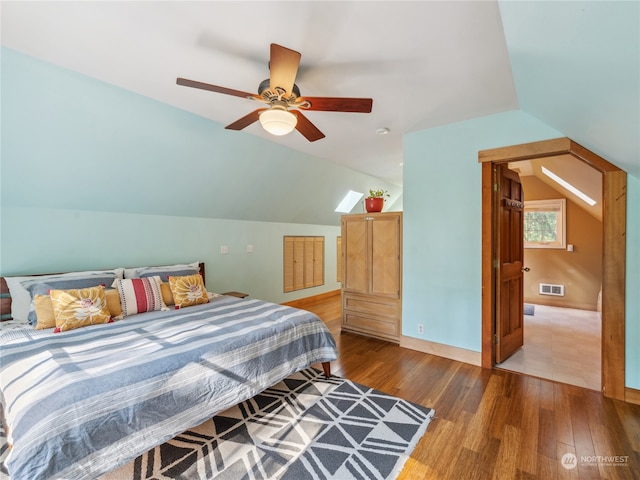 bedroom featuring ceiling fan, hardwood / wood-style flooring, and vaulted ceiling