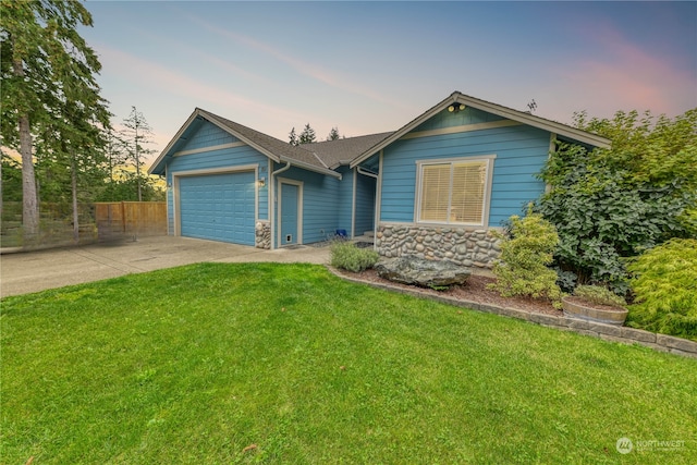 view of front facade with a yard and a garage