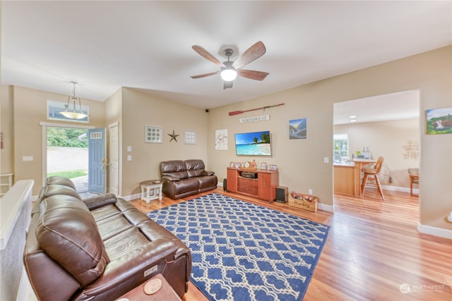 living room featuring ceiling fan and hardwood / wood-style flooring