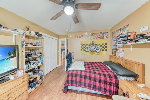 bedroom featuring ceiling fan, a closet, and light hardwood / wood-style flooring