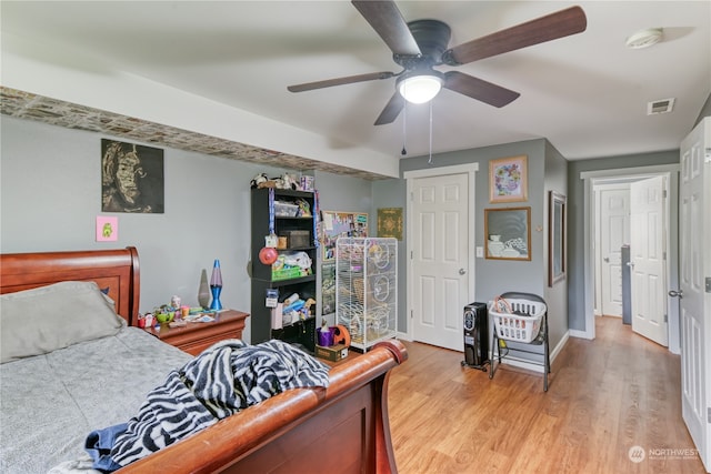 bedroom with light hardwood / wood-style floors and ceiling fan