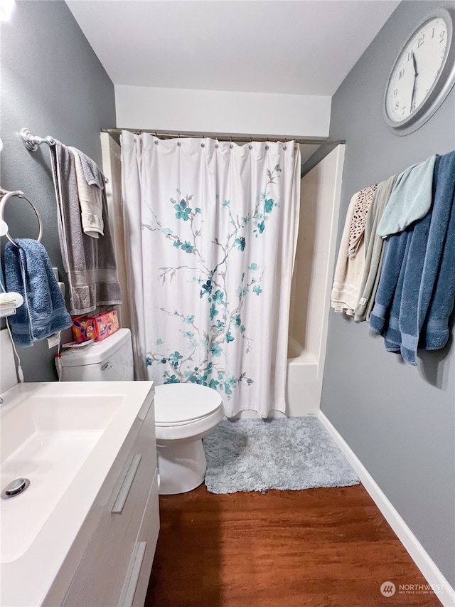 full bathroom with vanity, hardwood / wood-style flooring, toilet, and shower / bath combo