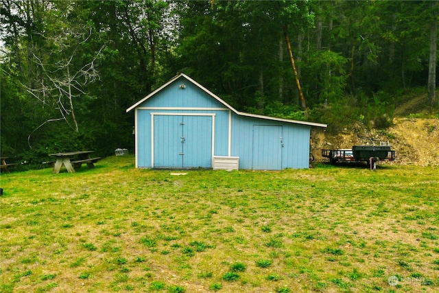 view of outbuilding featuring a lawn