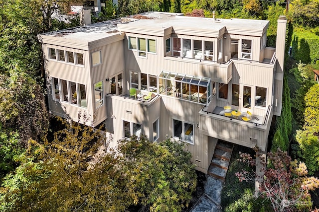 back of property with a balcony