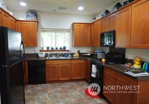 kitchen featuring sink and black appliances