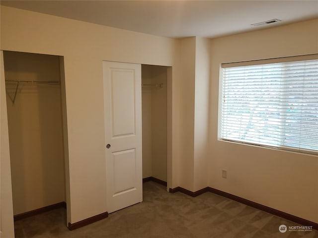 unfurnished bedroom featuring dark colored carpet