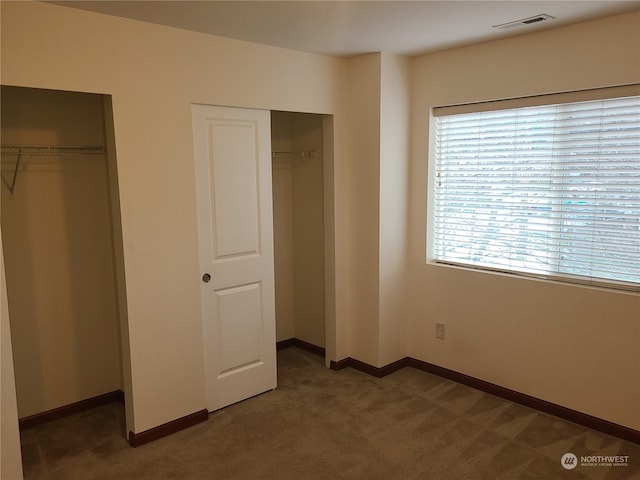 unfurnished bedroom featuring dark carpet