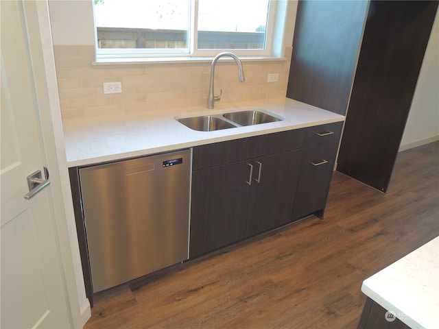 kitchen featuring dark hardwood / wood-style flooring, sink, dark brown cabinetry, and stainless steel dishwasher