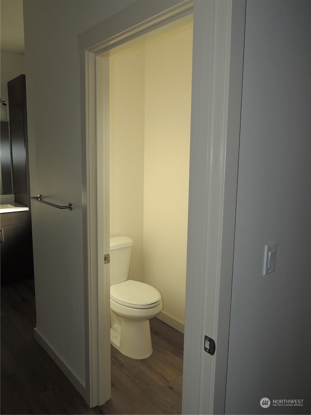 bathroom with hardwood / wood-style floors and toilet