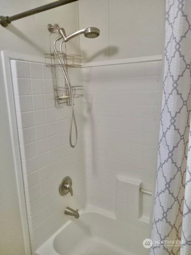 bathroom featuring shower / bathtub combination with curtain