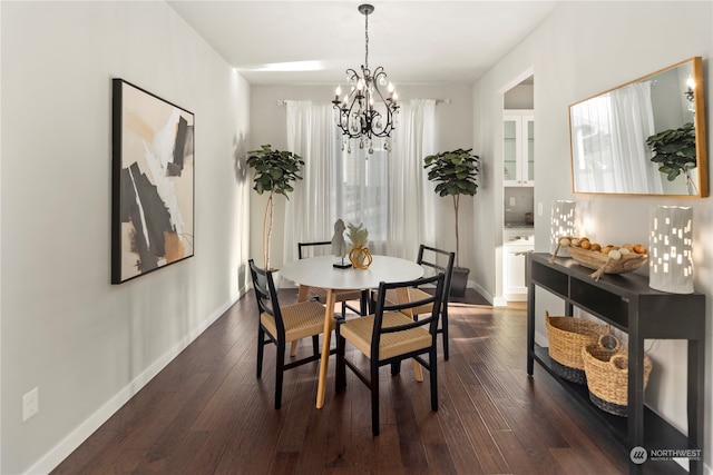 dining space with a notable chandelier and dark hardwood / wood-style flooring