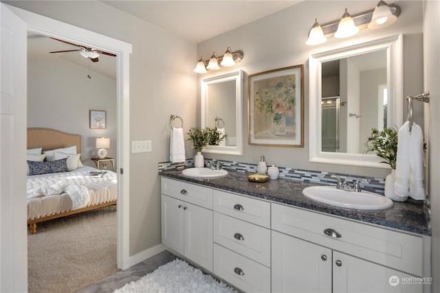 bathroom featuring ceiling fan, vanity, lofted ceiling, and an enclosed shower