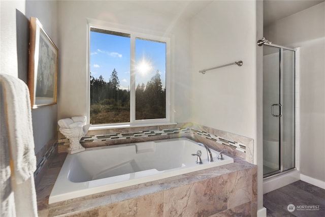 bathroom featuring separate shower and tub