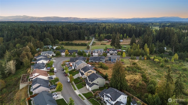 aerial view at dusk featuring a mountain view