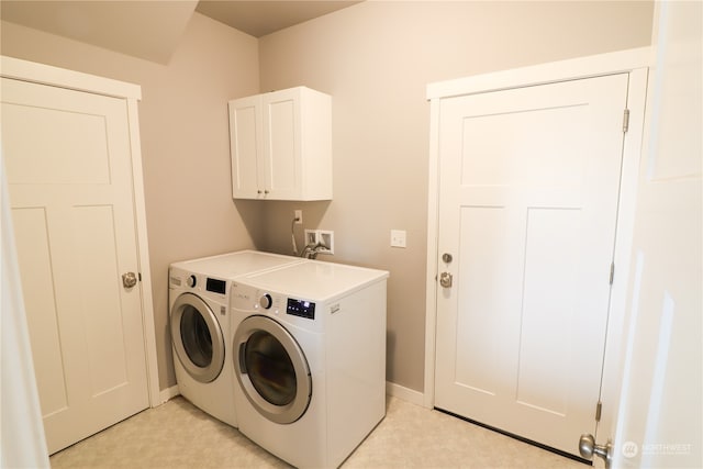 laundry room with cabinets and separate washer and dryer