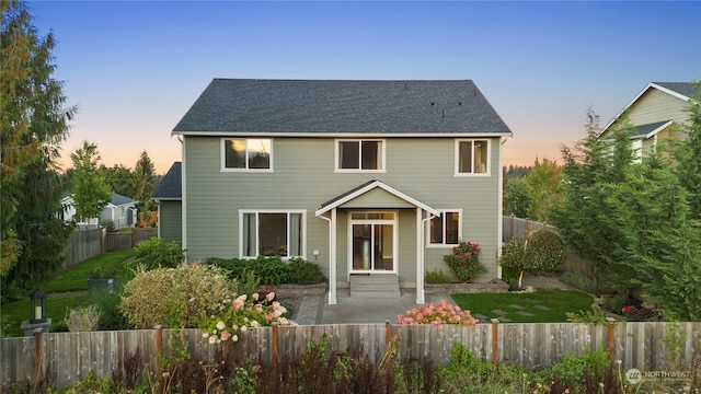 view of front of home with a yard and a patio