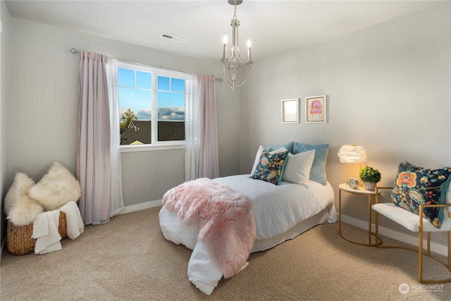 bedroom with light colored carpet and a notable chandelier